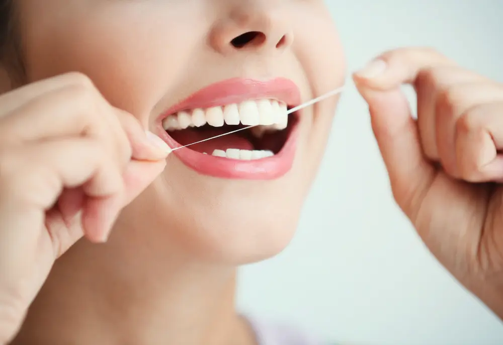 woman keeping up with her at-home oral hygiene