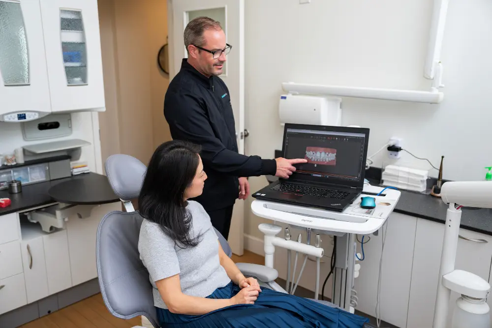 Dr. Leedy explaining dental implants to a patient