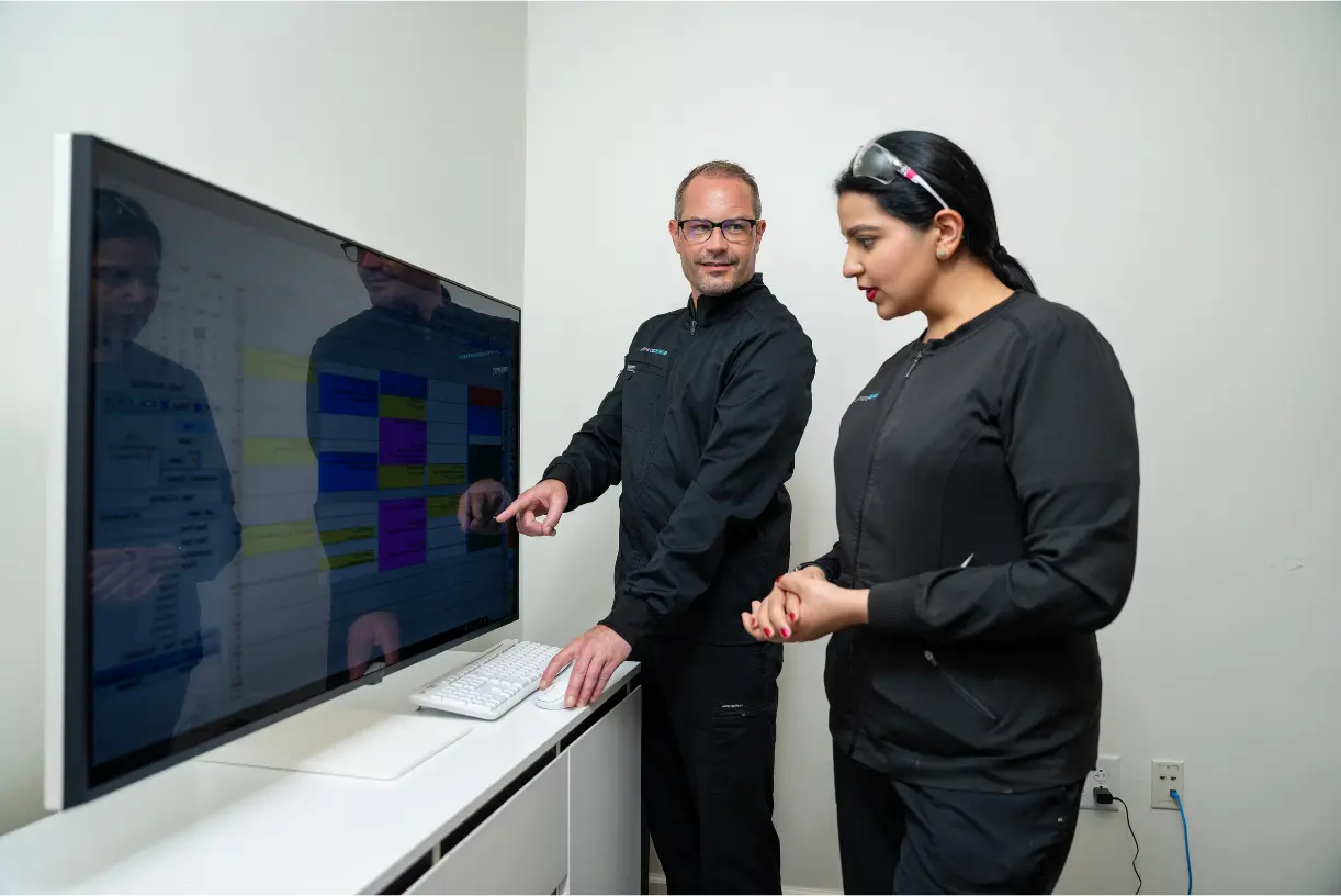 Dr. Leedy discussing treatment with his hygienist